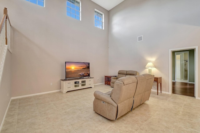 living room featuring a towering ceiling