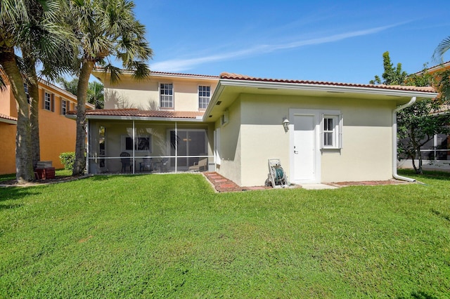 6716 Eagle Ridge Dr, Greenacres, FL 33413 - back of property with stucco siding, a lawn, a tile roof, and a sunroom