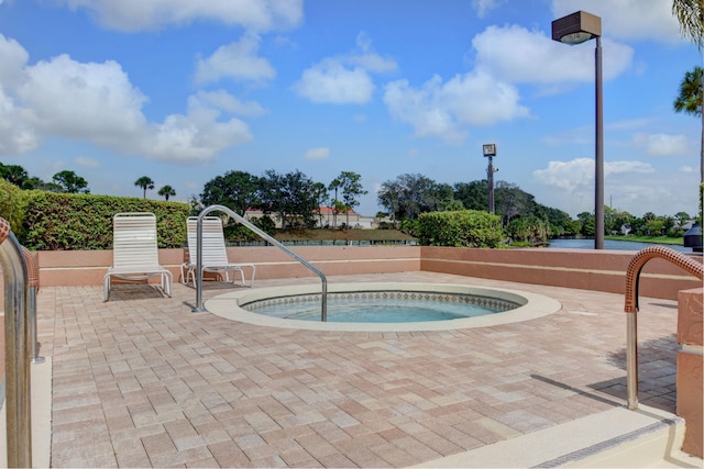 view of pool featuring a patio area and an in ground hot tub