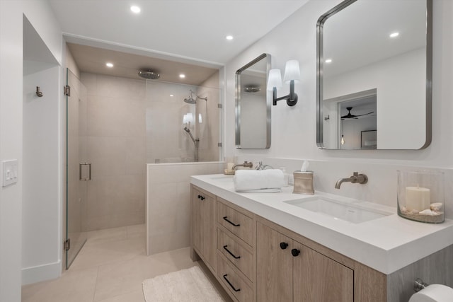 bathroom featuring tiled shower, tile patterned flooring, and vanity