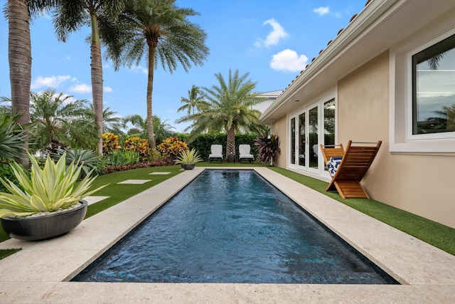 view of swimming pool with french doors