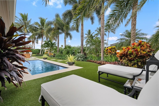 view of swimming pool with a yard and a patio