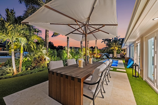 patio terrace at dusk with a yard