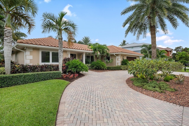 mediterranean / spanish-style house featuring a front lawn