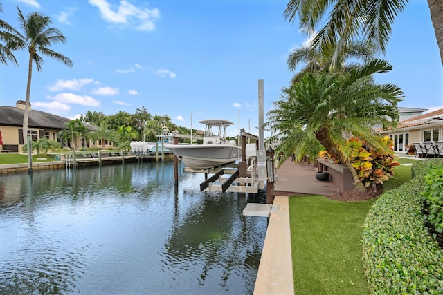 view of dock with a yard and a water view