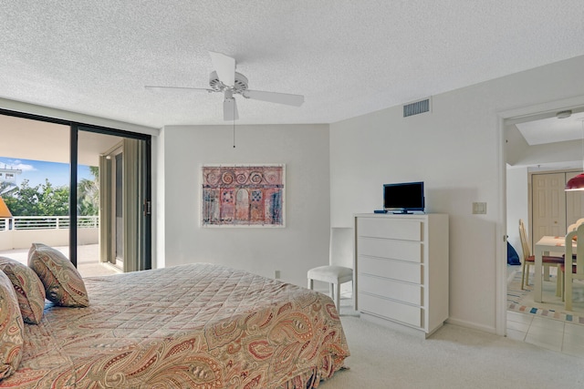 bedroom with ceiling fan, access to exterior, a textured ceiling, and light carpet