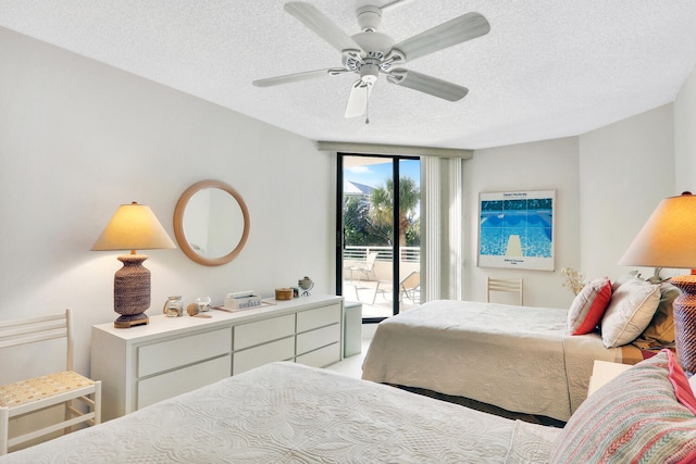 bedroom with access to outside, ceiling fan, and a textured ceiling