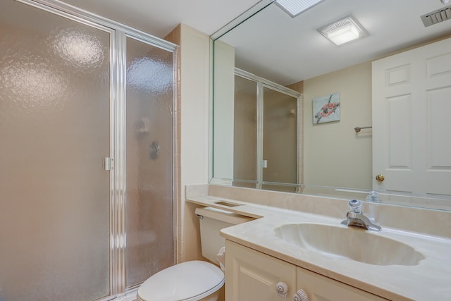 bathroom with vanity, toilet, and walk in shower