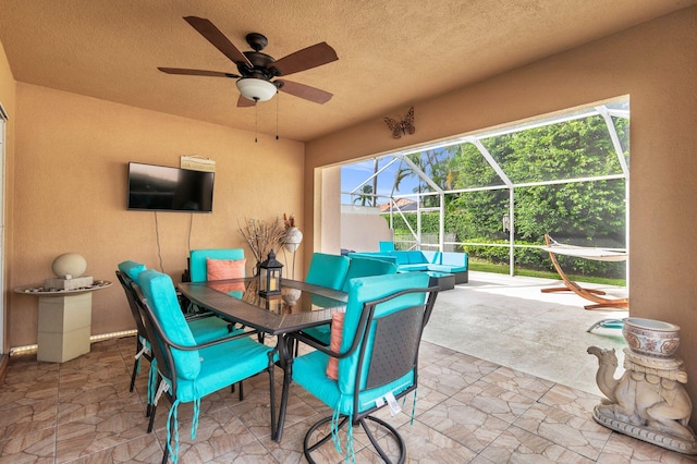 view of patio with a lanai and ceiling fan