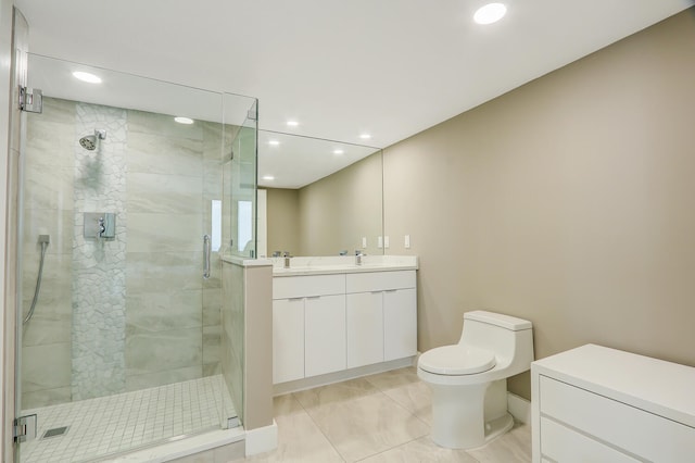 bathroom featuring tile patterned flooring, vanity, toilet, and a shower with shower door