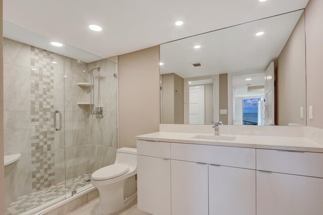 bathroom featuring vanity, toilet, and a shower with door