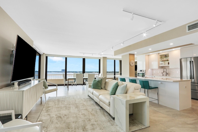 living room featuring sink and track lighting