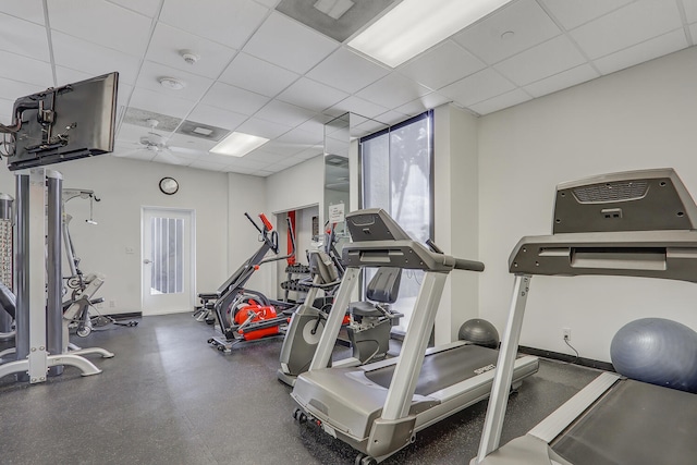 exercise room featuring a drop ceiling and ceiling fan