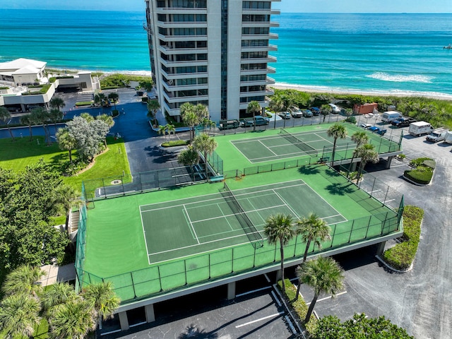 birds eye view of property with a water view and a beach view