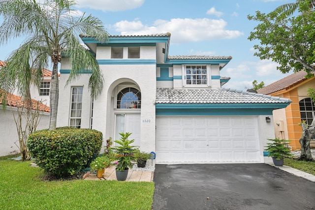 mediterranean / spanish-style home with a garage