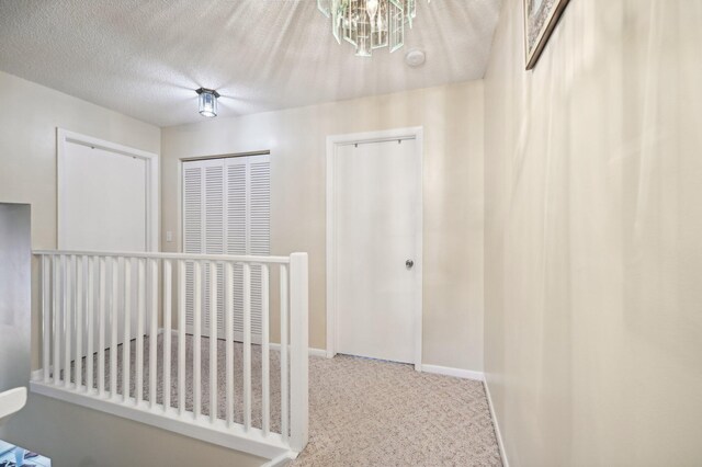 laundry area with independent washer and dryer, a textured ceiling, and light tile patterned floors