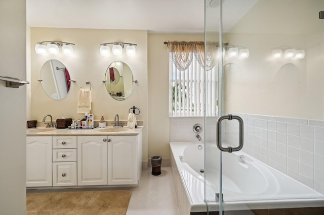 bathroom featuring tile patterned flooring, vanity, and a relaxing tiled tub