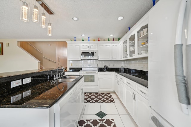 kitchen with white cabinets, white appliances, backsplash, and sink