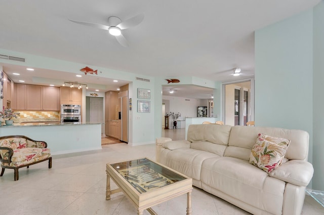 tiled living room with ceiling fan