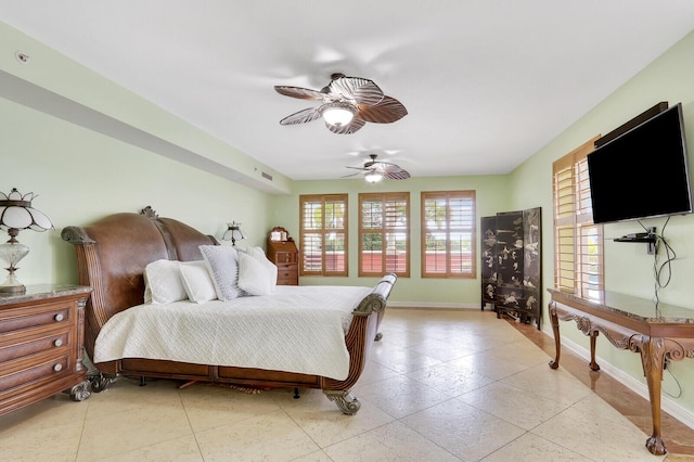 bedroom with baseboards, ceiling fan, and light tile patterned floors