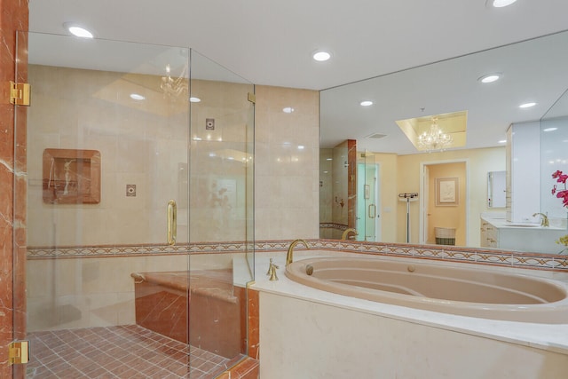 bathroom featuring vanity, independent shower and bath, and a chandelier