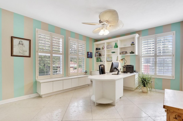 home office with baseboards, ceiling fan, and a healthy amount of sunlight