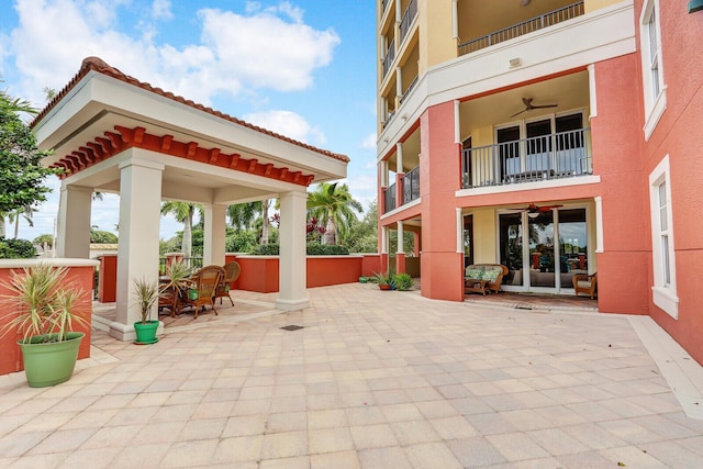 view of patio with a gazebo and a balcony