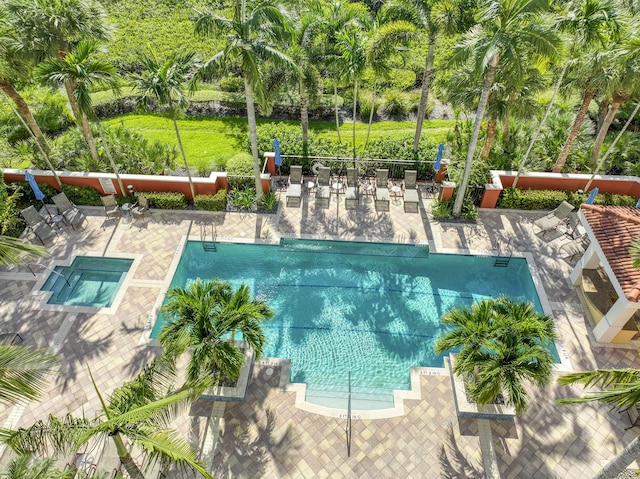 community pool with fence and a patio