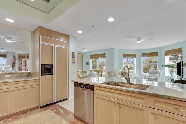 kitchen with a sink, paneled built in refrigerator, a ceiling fan, light stone countertops, and dishwasher