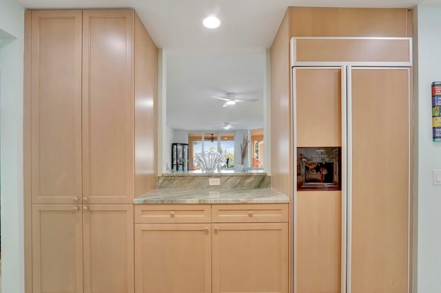 kitchen featuring light brown cabinets and paneled refrigerator