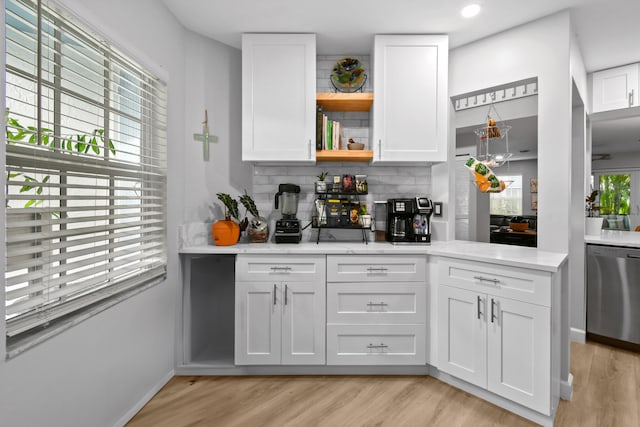 kitchen with white cabinetry, a healthy amount of sunlight, and stainless steel dishwasher