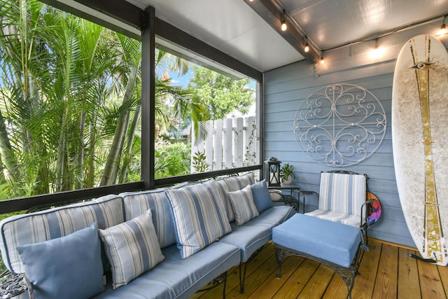 sunroom featuring track lighting