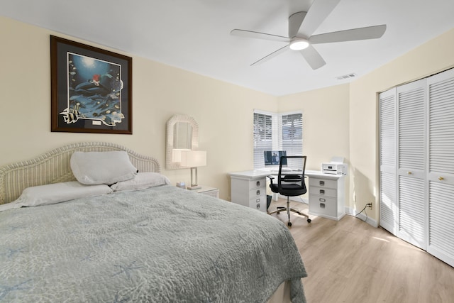 bedroom with light hardwood / wood-style flooring, a closet, and ceiling fan