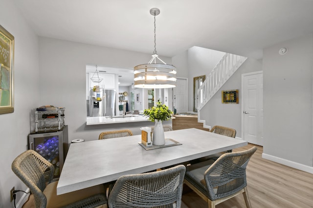 dining room featuring light hardwood / wood-style flooring and a chandelier