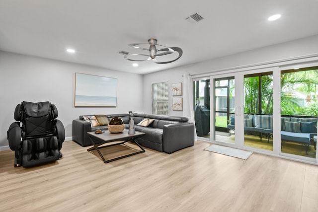 living room featuring ceiling fan and light hardwood / wood-style flooring