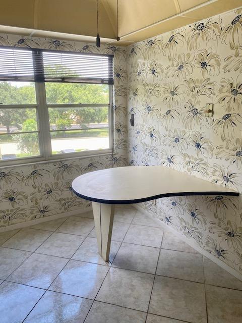 unfurnished dining area featuring light tile patterned floors