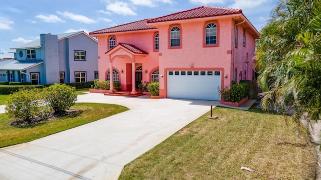 mediterranean / spanish-style house featuring a front yard and a garage