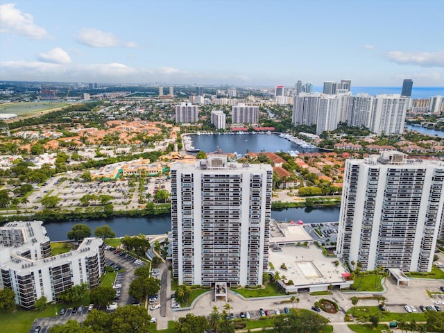 birds eye view of property with a view of city and a water view