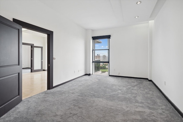 unfurnished room featuring baseboards, carpet flooring, and recessed lighting