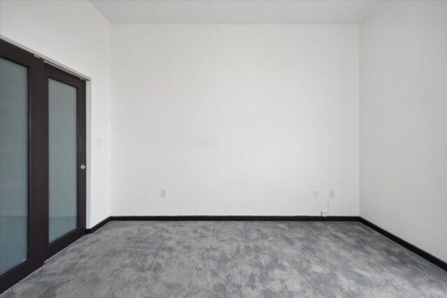 carpeted spare room with baseboards