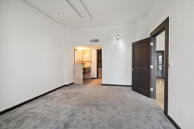 unfurnished bedroom with light carpet, baseboards, and visible vents