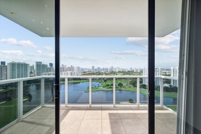 balcony with a water view and a view of city