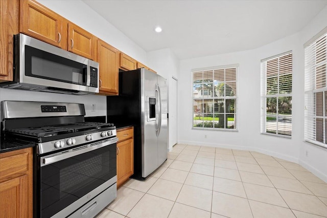 kitchen with appliances with stainless steel finishes and light tile patterned flooring