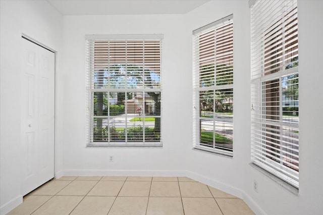 unfurnished room with light tile patterned floors