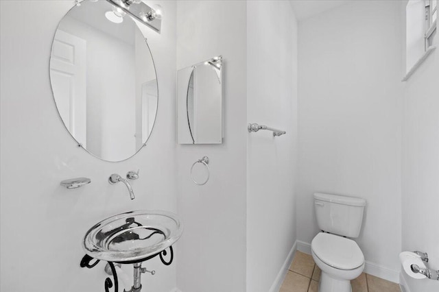 bathroom with toilet and tile patterned floors