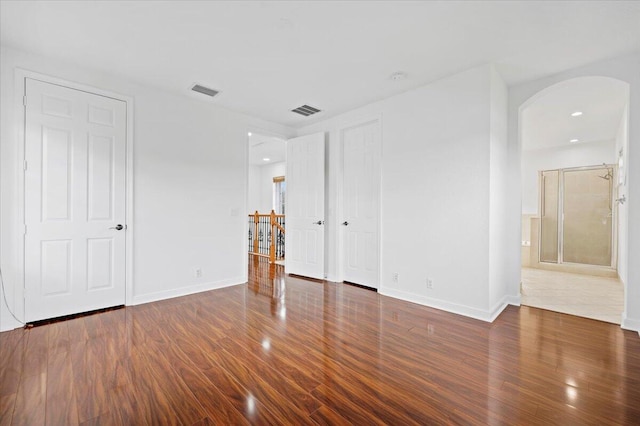 unfurnished room featuring dark wood-type flooring