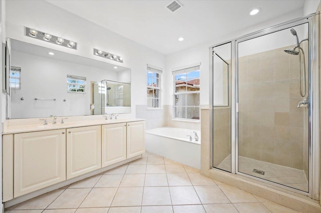 bathroom featuring vanity, plus walk in shower, and tile patterned flooring