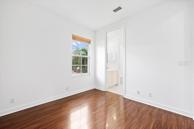 spare room featuring hardwood / wood-style floors