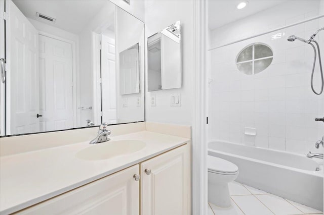 full bathroom with vanity, toilet, tiled shower / bath combo, and tile patterned floors