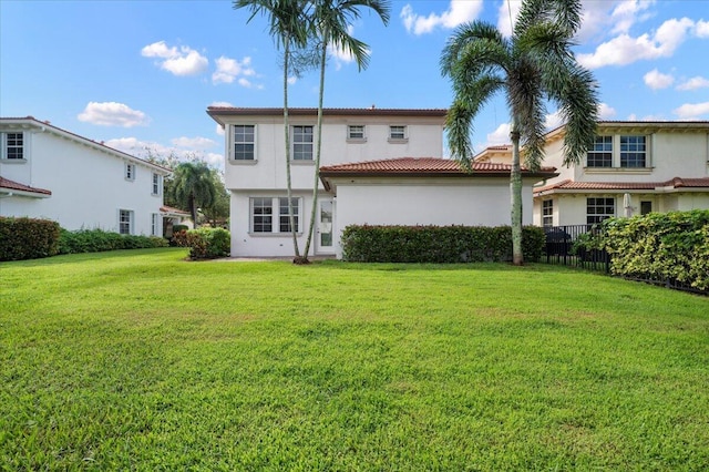 rear view of house with a lawn